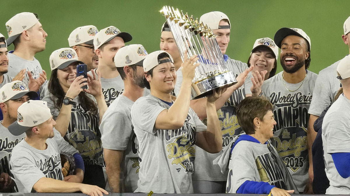 Los Angeles Dodgers two-way player Shohei Ohtani (17) celebrates with the Commissioner's Trophy after defeating the Toronto Blue Jays in game seven of the 2025 MLB World Series at Rogers Centre.