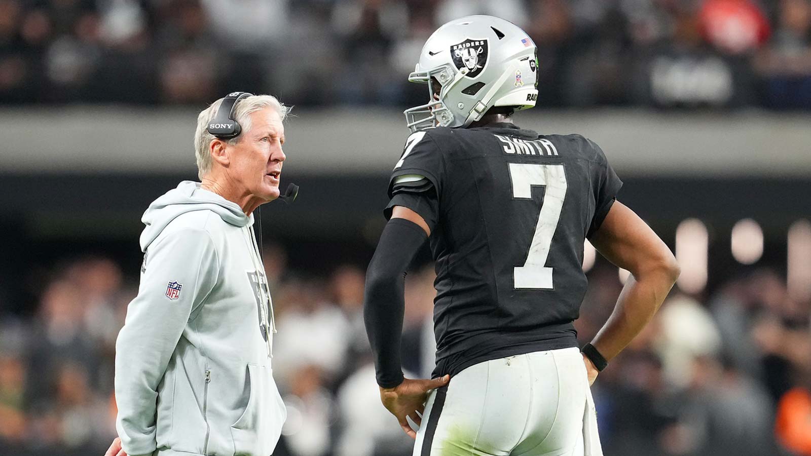 Las Vegas Raiders quarterback Geno Smith (7) talks to head coach Pete Carroll in game against the Cleveland Browns during the fourth quarter at Allegiant Stadium. Mandatory Credit: Stephen R. Sylvanie-Imagn Images