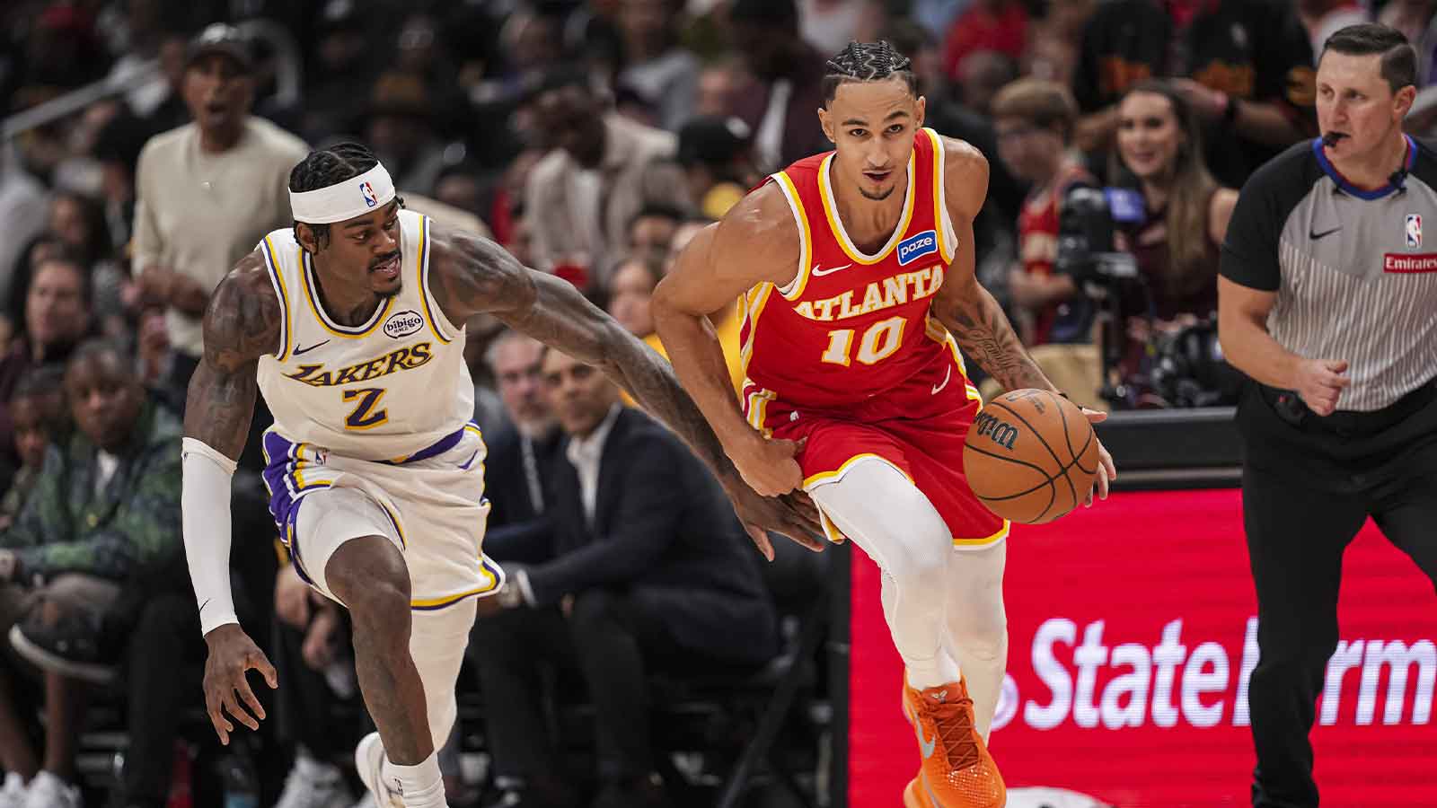 Atlanta Hawks forward Zaccharie Risacher (10) picks up a loose ball behind Los Angeles Lakers forward Jarred Vanderbilt (2) during the second half at State Farm Arena.