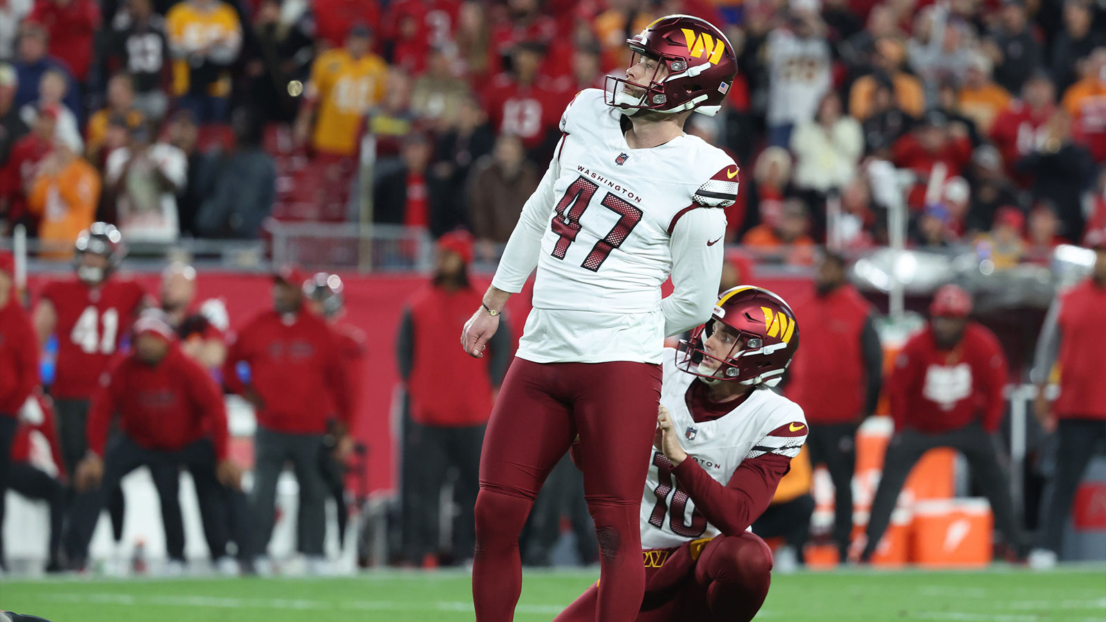 Washington Commanders place kicker Zane Gonzalez (47) kicks the game-winning field goal out of the hold of punter Tress Way (10) during the fourth quarter of a NFC wild card playoff against the Tampa Bay Buccaneers at Raymond James Stadium.