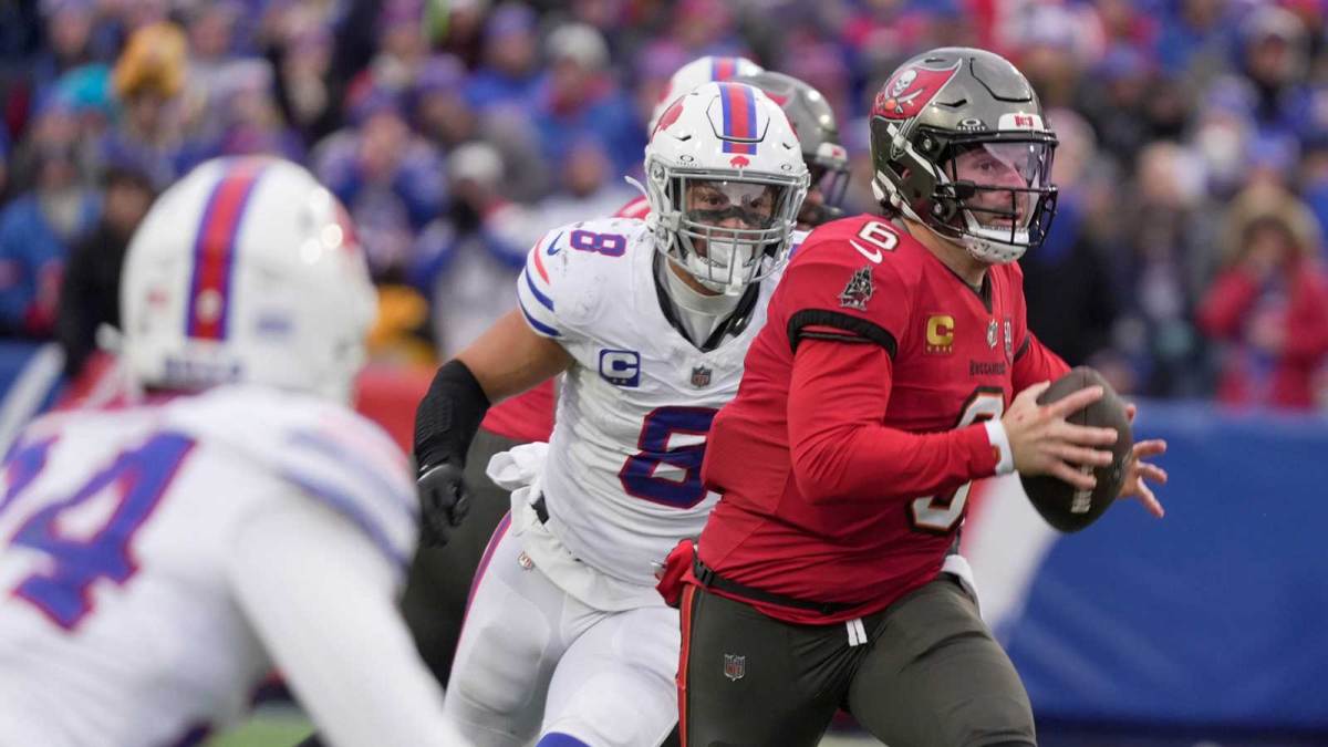 Tampa Bay Buccaneers quarterback Baker Mayfield runs with the ball gaining several yards on the play and avoiding Buffalo Bills linebacker Terrel Bernard and safety Cole Bishop during second half action against the Tampa Bay Buccaneers on Nov 16, 2025 at Highmark Stadium in Orchard Park.