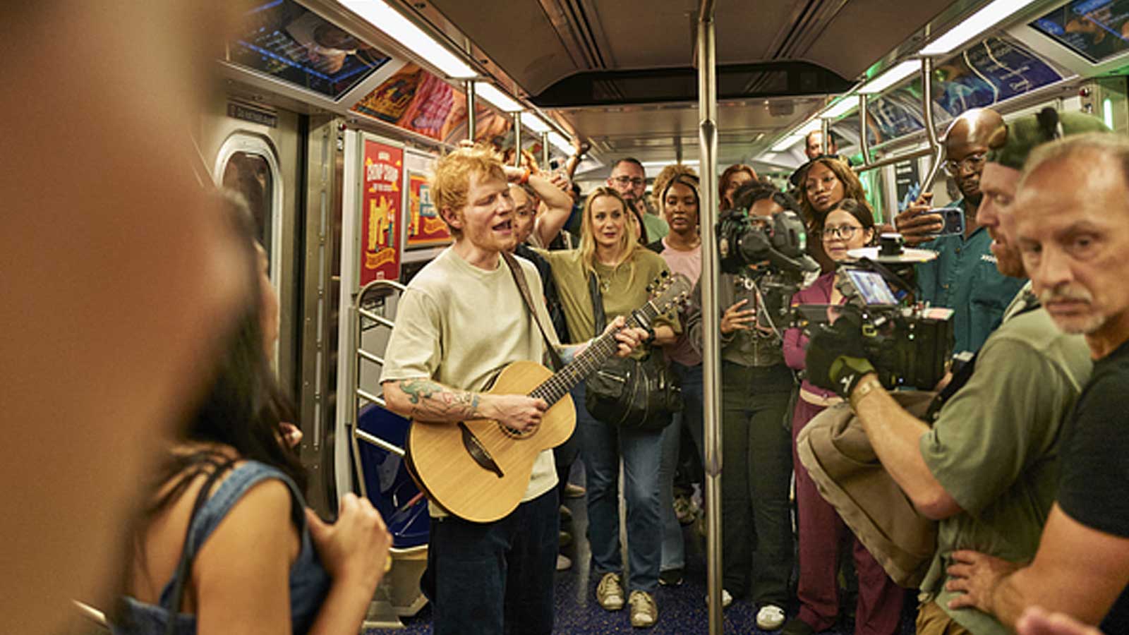 Ed Sheeran performing on the subway.