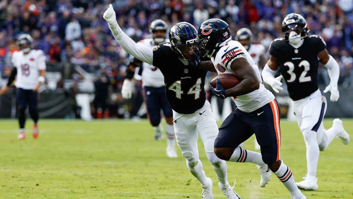 Chicago Bears running back D'Andre Swift (4) runs after making a catch as Baltimore Ravens cornerback Marlon Humphrey (44) attempts to make a tackle during the fourth quarter at M&T Bank Stadium.