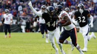 Chicago Bears running back D'Andre Swift (4) runs after making a catch as Baltimore Ravens cornerback Marlon Humphrey (44) attempts to make a tackle during the fourth quarter at M&T Bank Stadium.