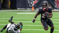 Houston Texans running back Woody Marks (27) rushes against Jacksonville Jaguars cornerback Greg Newsome II (6) in the second half at NRG Stadium.