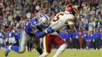 Seattle Seahawks linebacker Drake Thomas (42) tackles Washington Commanders quarterback Jayden Daniels (5) resulting in an injury during the second half at Northwest Stadium.