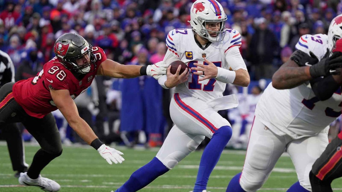 Buffalo Bills quarterback Josh Allen avoids Tampa Bay Buccaneers linebacker Anthony Nelson and runs for his third touchdown of the game during second half action against the Tampa Bay Buccaneers on Nov 16, 2025 at Highmark Stadium in Orchard Park.