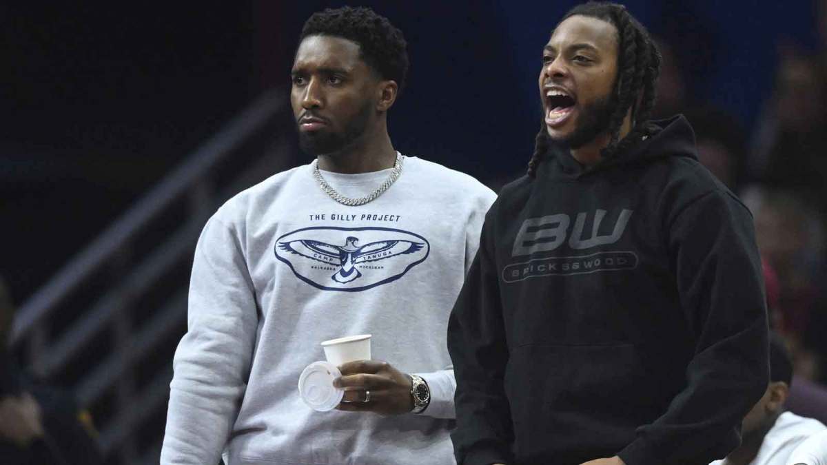 Cleveland Cavaliers guard Donovan Mitchell (left) and guard Darius Garland react on the bench in the third quarter against the Toronto Raptors at Rocket Arena.