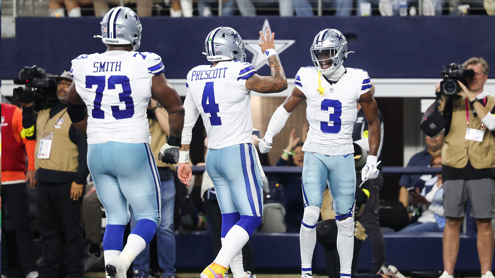 Dallas Cowboys wide receiver George Pickens (3) celebrates a touchdown with quarterback Dak Prescott (4) in the second quarter against the Philadelphia Eagles at AT&T Stadium.