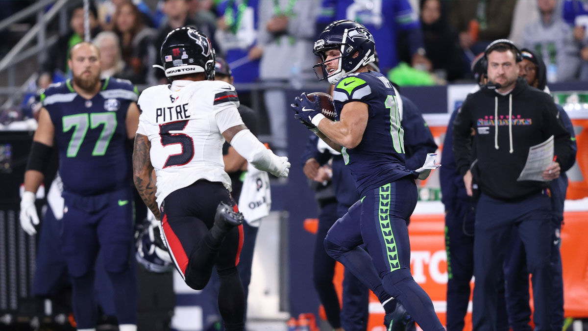 Seattle Seahawks wide receiver Cooper Kupp (10) runs after a catch against Houston Texans safety Jalen Pitre (5) during the first quarter at Lumen Field.