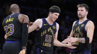 Los Angeles Lakers guard Austin Reaves (15) is congratulated by forward LeBron James (23) and guard Luka Doncic (77) after a three-point basket in the second quarter at Crypto.com Arena.