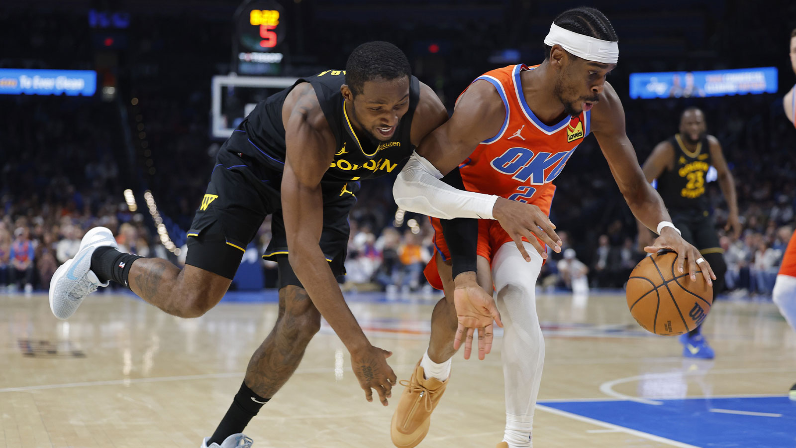 Golden State Warriors forward Jonathan Kuminga (1) and Oklahoma City Thunder guard Shai Gilgeous-Alexander (2) fight for control of the ball during the second half at Paycom Center. 