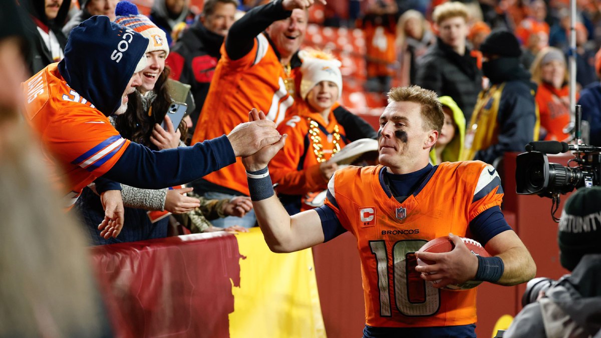 Denver Broncos quarterback Bo Nix (10) celebrates with fans after the game against the Washington Commanders at Northwest Stadium.