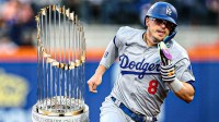Kike Hernandez in Dodgers' uniform with World Series Trophy next to him.