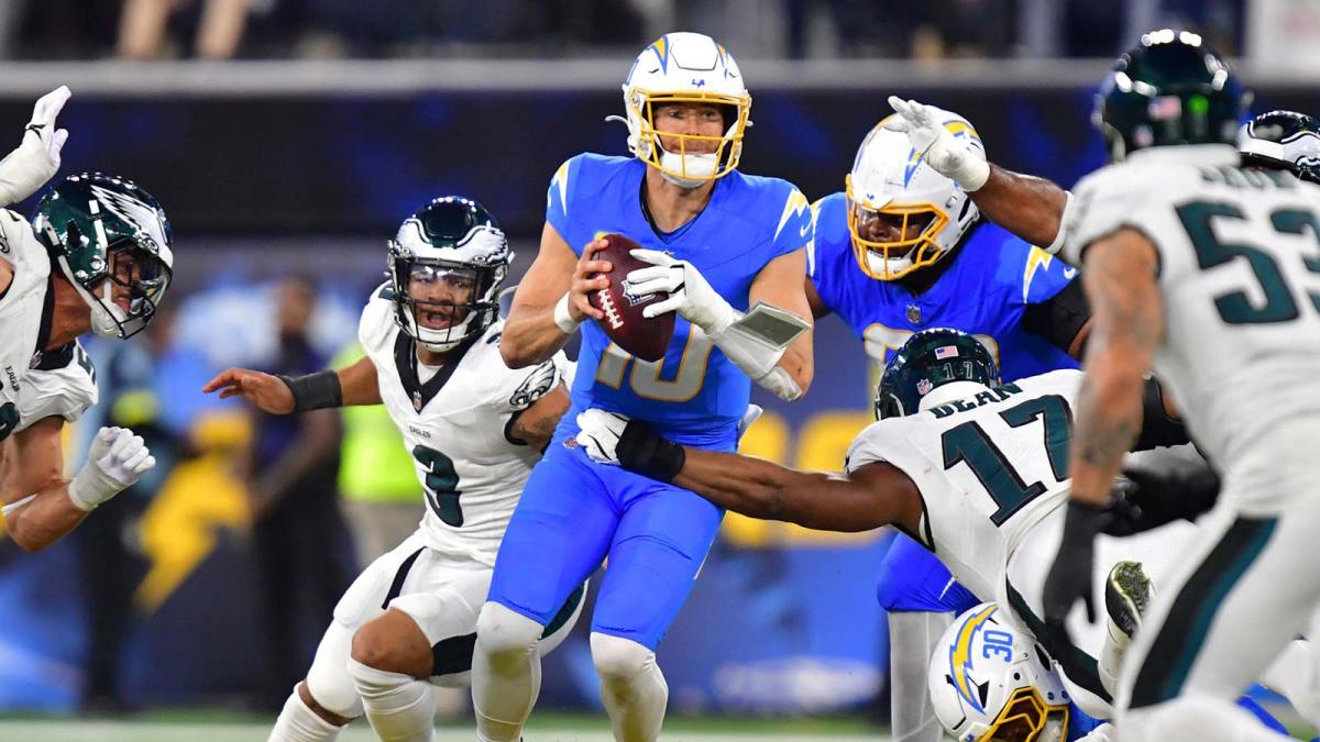 Los Angeles Chargers quarterback Justin Herbert (10) looks to pass against Philadelphia Eagles linebacker Nakobe Dean (17) in the second half at SoFi Stadium.