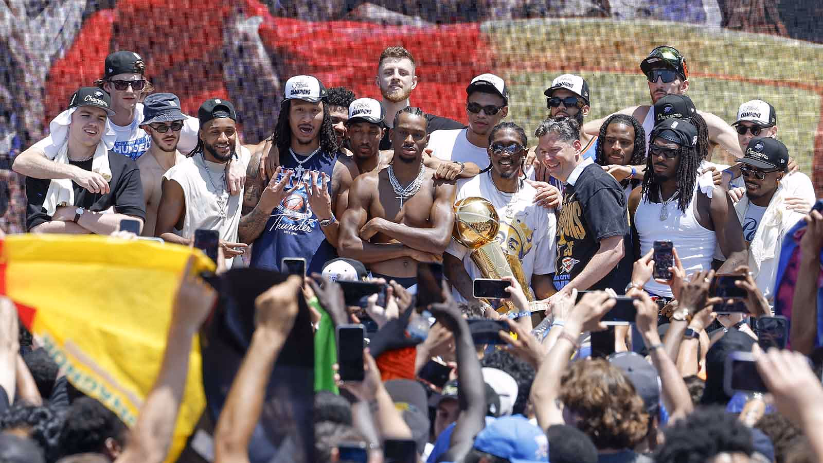 Oklahoma City Thunder team members pose for a photo at the closing ceremony of the Oklahoma City Thunder Champions parade.