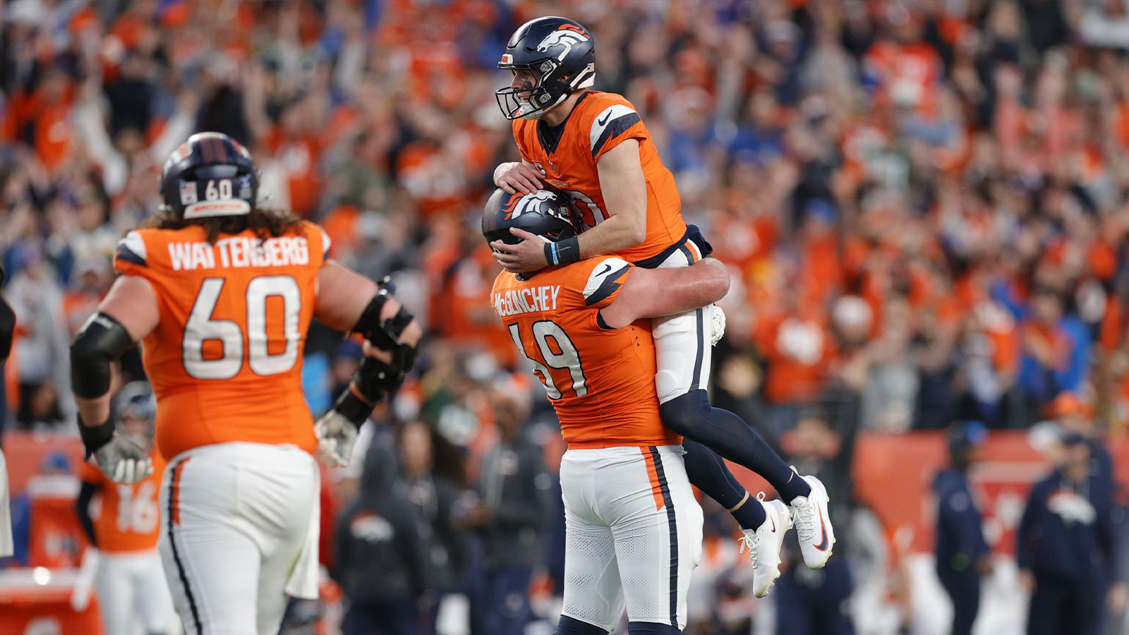 Denver Broncos quarterback Bo Nix (10) celebrates a touchdown with offensive tackle Mike McGlinchey (69) during the third quarter against the Green Bay Packers at Empower Field at Mile High.