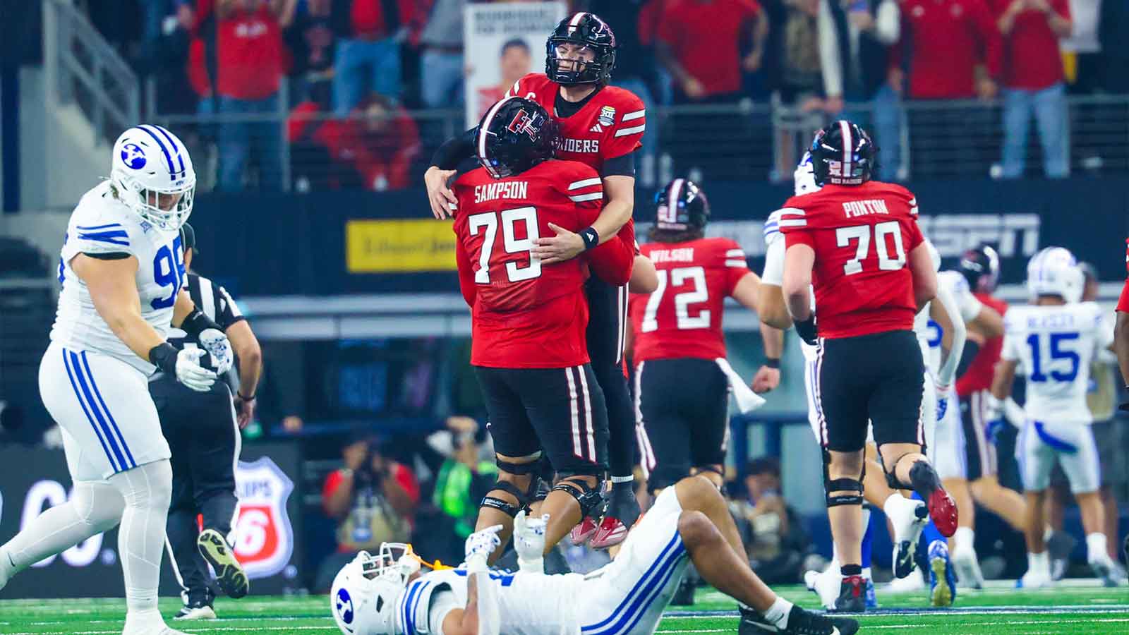 Texas Tech Red Raiders quarterback Behren Morton (2) celebrates with Texas Tech Red Raiders offensive lineman Howard Sampson (79) after throwing a touchdown pass during the first half against the BYU Cougars at AT&T Stadium.