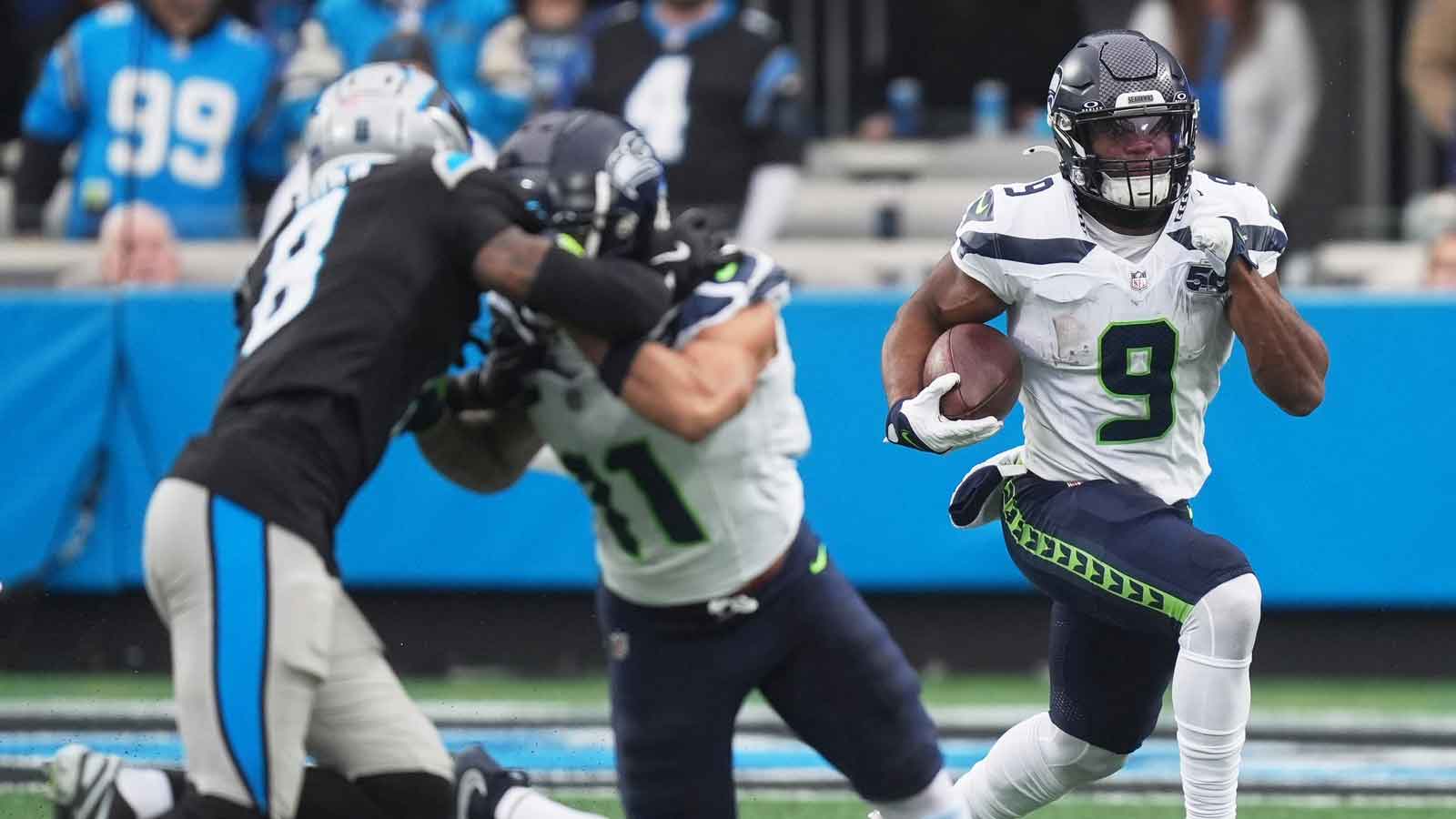 Seattle Seahawks running back Kenneth Walker III (9) runs the ball against Carolina Panthers cornerback Jaycee Horn (8) during the first quarter at Bank of America Stadium.