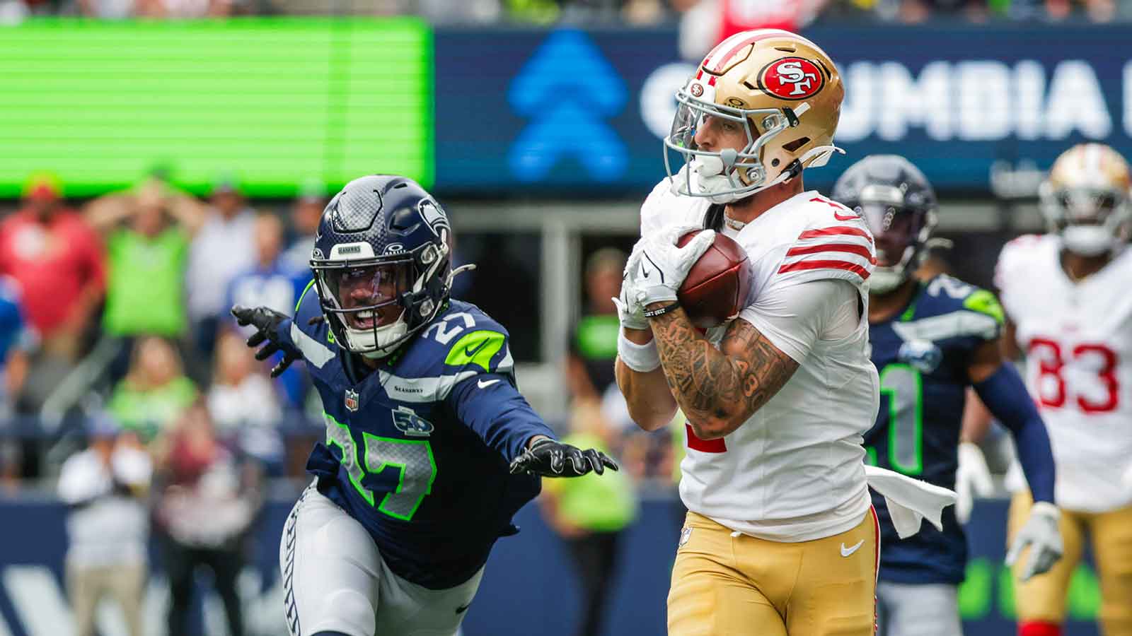 San Francisco 49ers wide receiver Ricky Pearsall (1) catches a pass against Seattle Seahawks cornerback Riq Woolen (27) during the fourth quarter at Lumen Field.