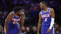 Philadelphia 76ers guard Tyrese Maxey (0) and center Joel Embiid (21) talks during a break in action in the second quarter against the Charlotte Hornets at Xfinity Mobile Arena.