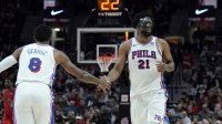 Philadelphia 76ers center Joel Embiid (21) and forward Paul George (8) high five during the second half against the Portland Trail Blazers at Moda Center.