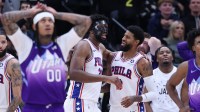 Philadelphia 76ers center Joel Embiid (21) and forward Paul George (8) react to a play against the Utah Jazz during the fourth quarter at Delta Center.