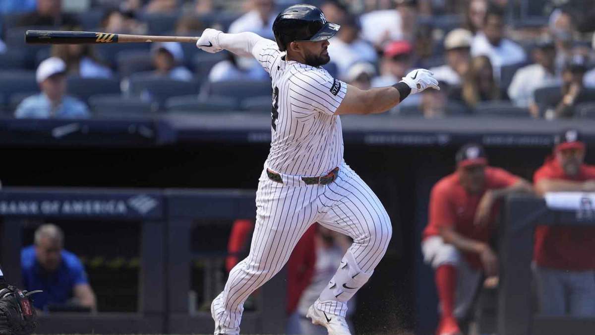 New York Yankees left fielder Jasson Dominguez (24) hits an infield single against the Washington Nationals during the third inning at Yankee Stadium.