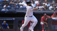 New York Yankees left fielder Jasson Dominguez (24) hits an infield single against the Washington Nationals during the third inning at Yankee Stadium.
