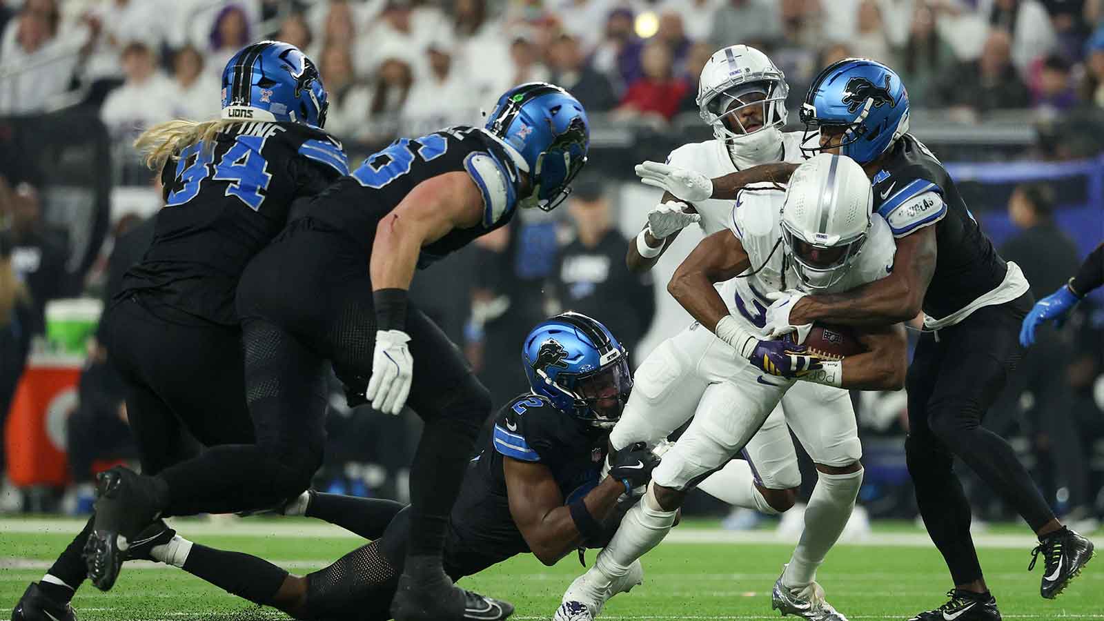 Detroit Lions safety Daniel Thomas (2) and cornerback D.J. Reed (4) tackle Minnesota Vikings running back Aaron Jones Sr. (33) in the first quarter at U.S. Bank Stadium.
