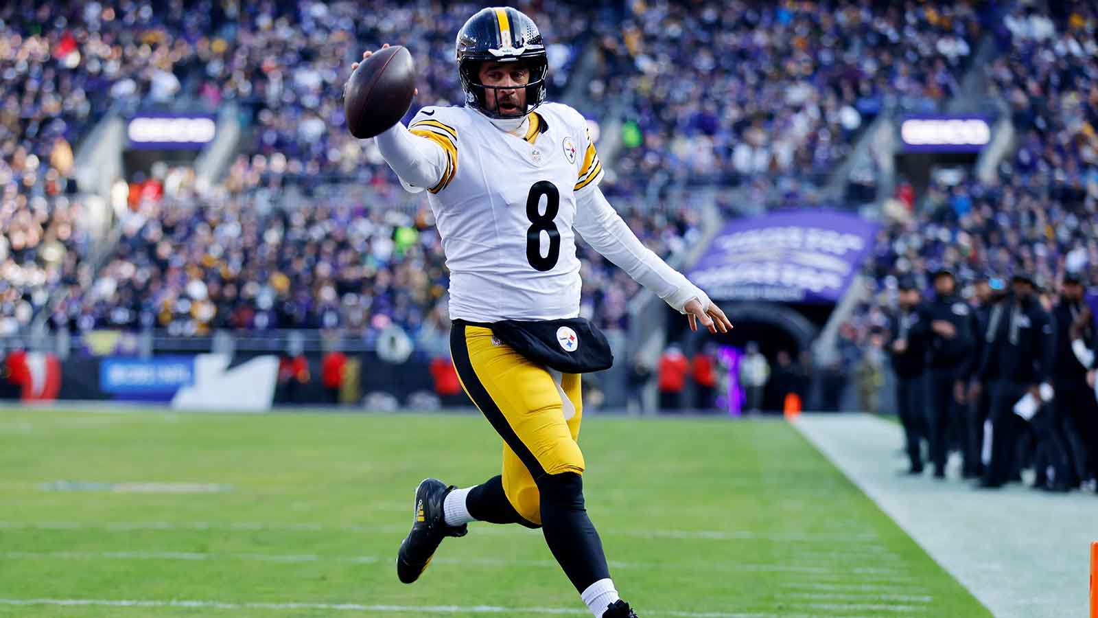 Pittsburgh Steelers quarterback Aaron Rodgers (8) scores a touchdown against the Baltimore Ravens during the first half at M&T Bank Stadium.