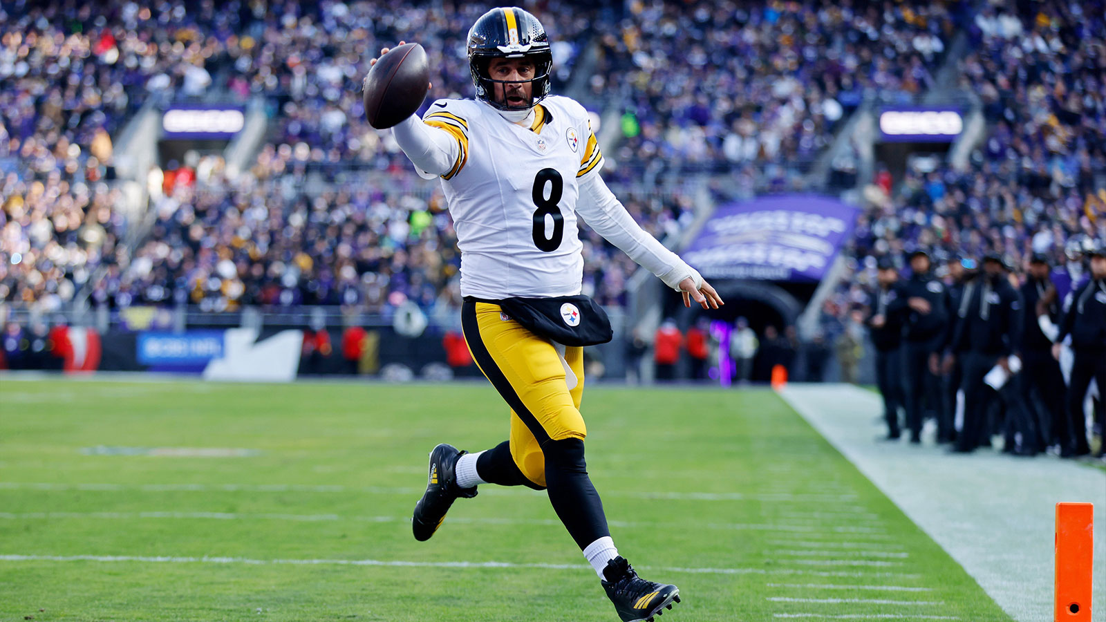 Pittsburgh Steelers quarterback Aaron Rodgers (8) scores a touchdown against the Baltimore Ravens during the first half at M&T Bank Stadium. 