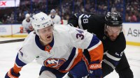 New York Islanders defenseman Adam Boqvist (34) skates for the puck as Tampa Bay Lightning center Zemgus Girgensons (28) defends during the third period at Benchmark International Arena.