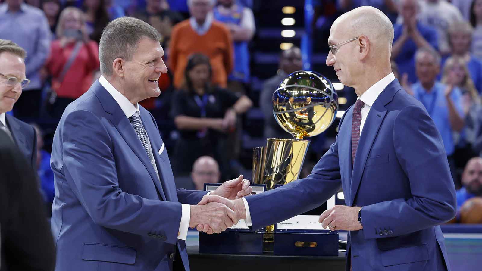 Oklahoma City Thunder chairman and owner Clay Bennett shakes hands with NBA commissioner Adam Silver during the ring ceremony at Paycom Center.