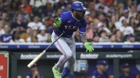 Texas Rangers pinch hitter Adolis Garcia hits an RBI single during the eighth inning against the Houston Astros at Daikin Park.