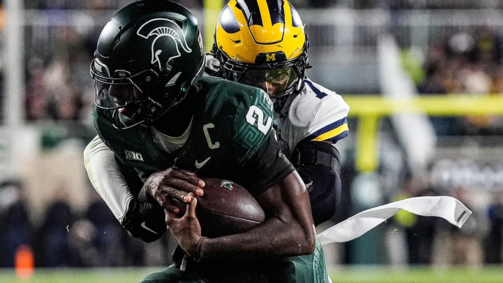 Michigan defensive back TJ Metcalf (7) tackles Michigan State quarterback Aidan Chiles (2) during the second half at Spartan Stadium in East Lansing on Saturday, October 25, 2025.