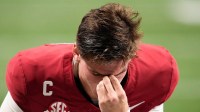 Alabama Crimson Tide quarterback Ty Simpson (15) kneels before the game against the Georgia Bulldogs during the 2025 SEC Championship game at Mercedes-Benz Stadium.