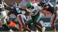 Tulane Green Wave defensive linemen Tre'Von McAlpine (95) reaches for Mississippi Rebels running back Kewan Lacy (5) as he runs the ball during the fourth quarter at Vaught-Hemingway Stadium.