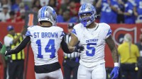 Detroit Lions running back David Montgomery (5) celebrates with wide receiver Amon-Ra St. Brown (14) after scoring a touchdown during the third quarter against the Houston Texans at NRG Stadium.
