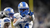 Detroit Lions wide receiver Amon-Ra St. Brown (14) celebrates after a play during the first half against the Dallas Cowboys at Ford Field.