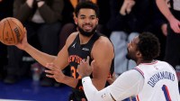 Dec 19, 2025; New York, New York, USA; New York Knicks center Karl-Anthony Towns (32) looks to pass the ball against Philadelphia 76ers center Andre Drummond (1) during the first quarter at Madison Square Garden. Mandatory Credit: Brad Penner-Imagn Images
