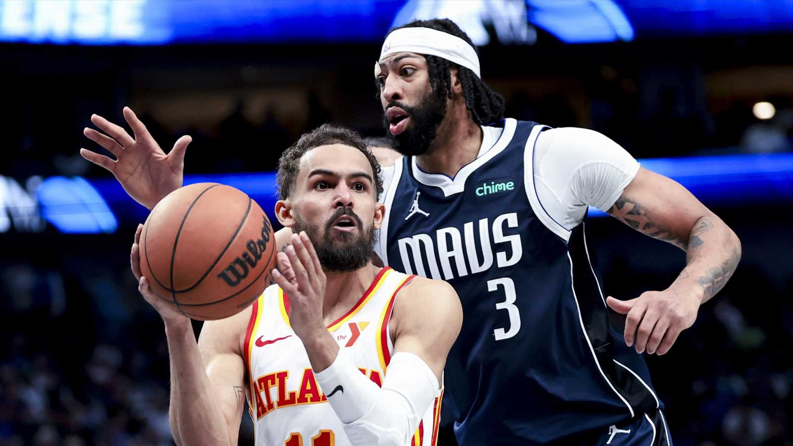 Atlanta Hawks guard Trae Young (11) looks to pass as Dallas Mavericks forward Anthony Davis (3) defends during the fourth quarter at American Airlines Center.