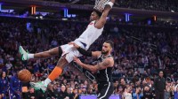 New York Knicks forward OG Anunoby (8) dunks past Brooklyn Nets guard Tyrese Martin (13) in the first quarter at Madison Square Garden.