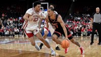 Houston Cougars guard Milos Uzan (7) tries to drive past Arkansas Razorbacks forward Malique Ewin (12) during the second half at Prudential Center.