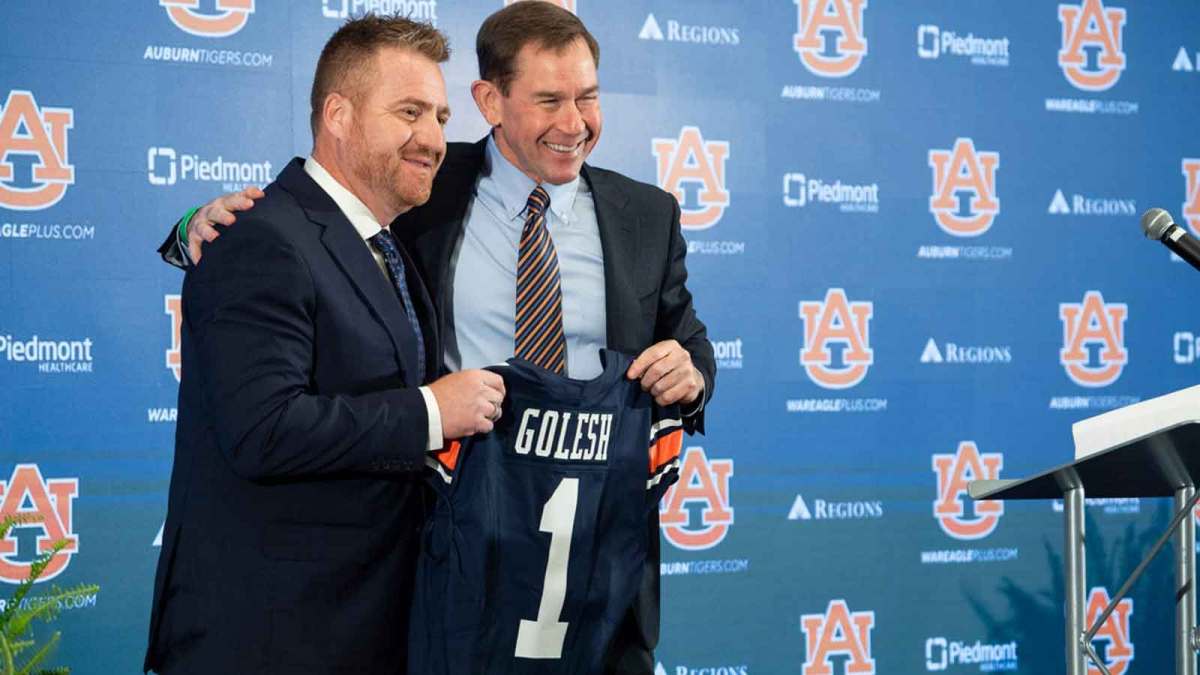 Auburn football head coach Alex Golesh and Auburn athletic director John Cohen pose for photos during his introductory press conference at Jordan-Hare Stadium in Auburn