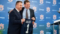 Auburn football head coach Alex Golesh and Auburn athletic director John Cohen pose for photos during his introductory press conference at Jordan-Hare Stadium in Auburn
