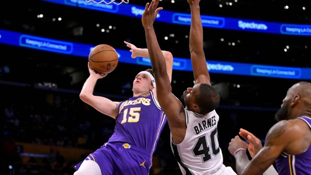Los Angeles Lakers guard Austin Reaves (15) is fouled by San Antonio Spurs forward Harrison Barnes (40) as he makes a shot during the second half at Crypto.com Arena.