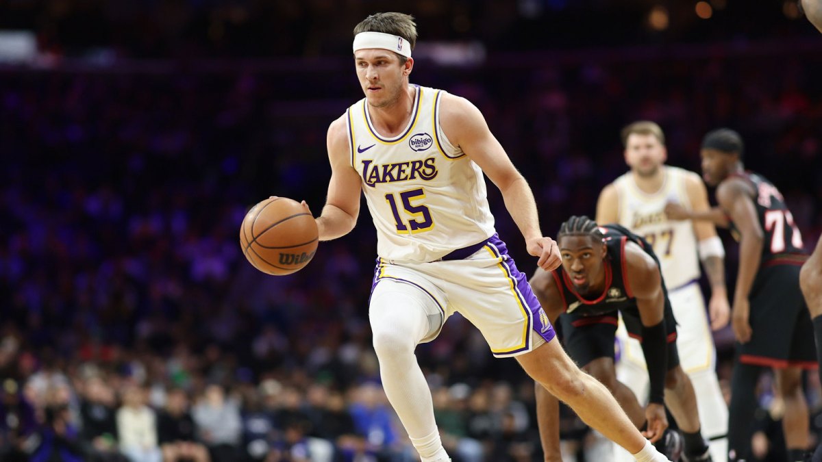 Los Angeles Lakers guard Austin Reaves (15) dribbles past Philadelphia 76ers guard Tyrese Maxey during the first quarter at Xfinity Mobile Arena.