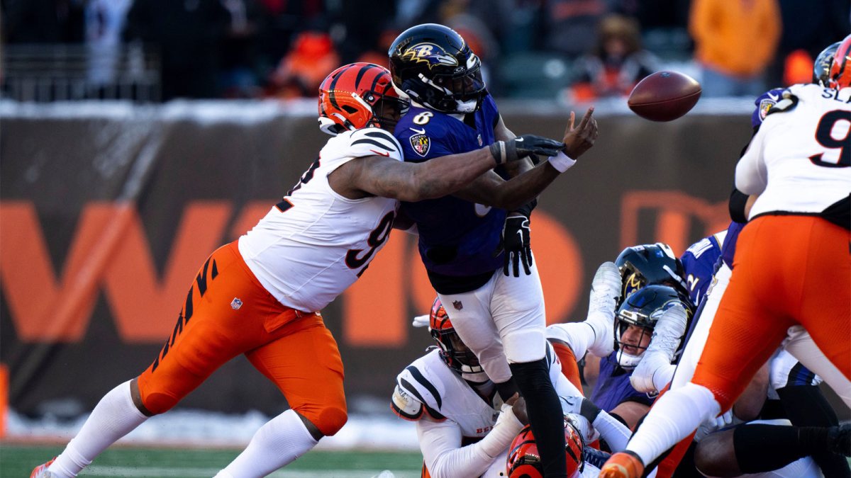 Baltimore Ravens quarterback Lamar Jackson (8) throws an incomplete pass as Cincinnati Bengals defensive tackle B.J. Hill (92) pressures him in the third quarter of the NFL football game at Paycor Stadium in Cincinnati on Dec. 14, 2025.