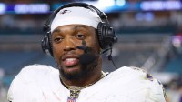 Baltimore Ravens running back Derrick Henry (22) wears a butterfly necklace during a postgame interview following a win over the Miami Dolphins at Hard Rock Stadium.